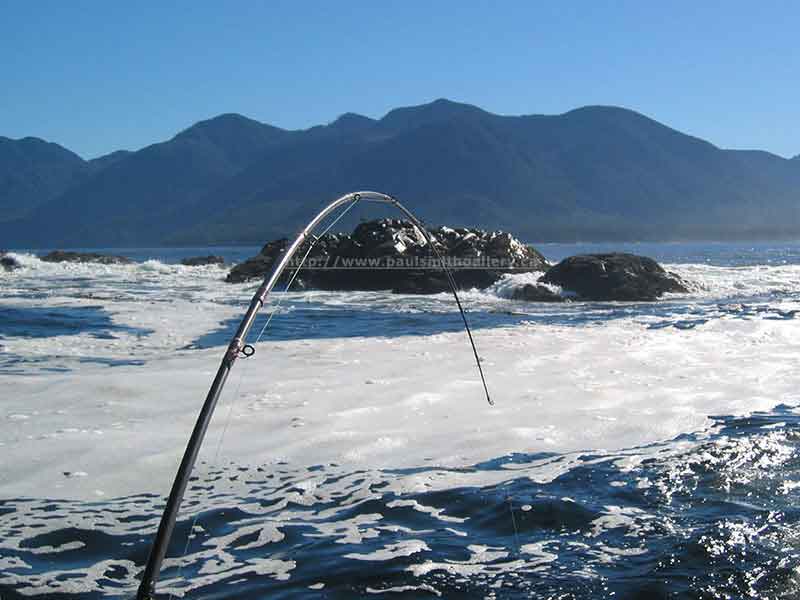 photo of a fishing rod in a boat fishing the surf of Nootka Sound