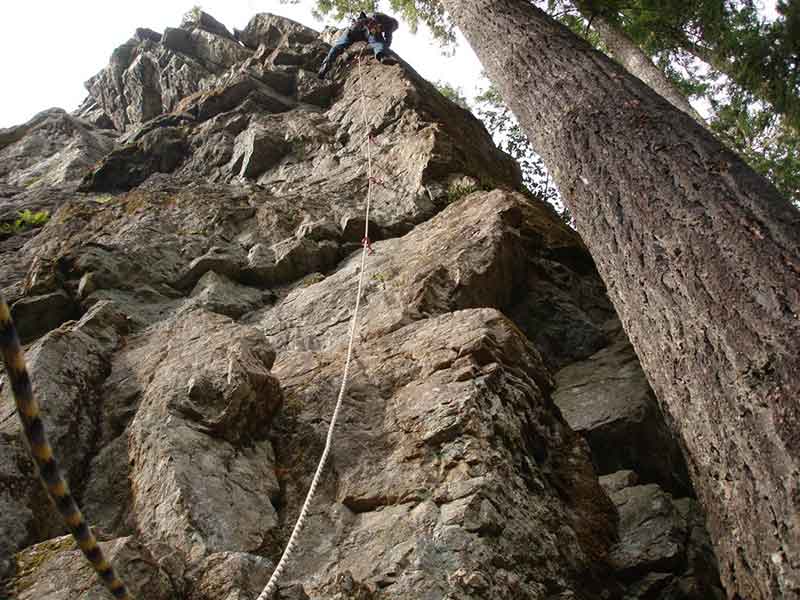 photo of a caver scaling a cliff