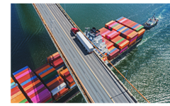 photo of shipping container traveling under bridge